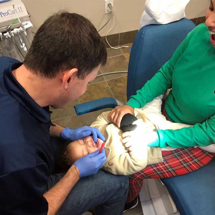knee to knee exam for a child's first dental visit